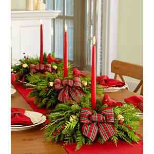 Holiday table decor with greenery, candles and ribbon