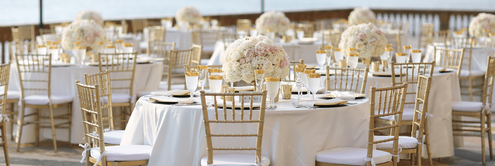 Event rentals including chiavari chairs and tablecloths with flowers designed by Beneva Weddings & Events in Sarasota FL