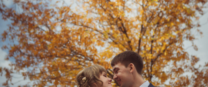 young bride and groom  on the background of the autumn landscape